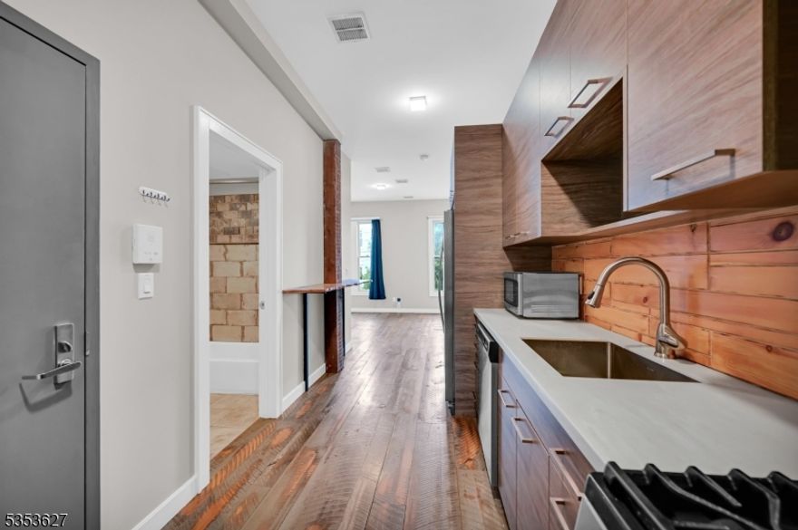 Experience the urban charm of CITY STYLE living in the heart of DOWNTOWN Newton with our stunning STUDIO apartment on the THIRD FLOOR overlooking Spring St! This fully renovated space offers high ceilings, large windows, and wide plank wood flooring, creating the perfect environment to work, relax, cook, and entertain all in one. The modern cabinetry and natural gas range add a chic touch to your culinary adventures, while the reclaimed wood custom breakfast bar provides a cozy spot for morning coffee. The built-in cabinetry extends from the kitchen to a HUGE wardrobe closet, ensuring ample storage. Enjoy the convenience of in-unit laundry, and feel secure with the building's intercom system and coded entry. Step outside to discover downtown restaurants, shops and small grocery just a few steps away. Newton residents also enjoy FREE membership to the nearby Newton Town Pool at Memory Park. Big box stores and fast casual spots like Starbucks, Chipotle, and Panera are just ONE MILE away.