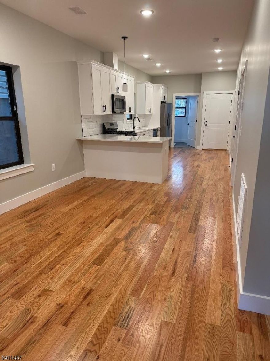 Completely renovated 3-bedroom, 2-bath apartments available in this building (3 available units). Each unit offers a well-designed layout with a spacious primary (master) bedroom with bath plus two additional bedrooms. Features include open-concept living areas with hardwood floors and recessed lighting, modern kitchens with stainless steel appliances, quartz countertops, and custom cabinetry. Central air and heat, laundry hookups, and ample closet space throughout. Ideal for commuters with easy access to NJ Transit, major highways, shopping, and dining. Move-in ready schedule your showing today.