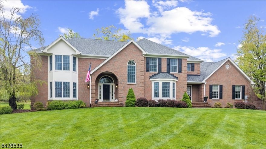 Two acres of mature landscaping, and the house lives up to the setting, a clean sight line front to back, a floor-to-ceiling brick fireplace anchoring the living room, hardwood floors and crown molding running through every room like the house was always meant to feel this intentional. Four bedrooms, a layout that actually makes sense, and enough space to breathe.The kitchen earns its keep: granite counters, stainless appliances, a center island with seating and storage, and sliding doors that spill out onto the deck for long summer evenings. A bay-windowed dining room sits ready for a real dinner party. There's generous additional living space for the nights that stretch long, and a private office with a wet bar for the ones that don't quite end at five. Powder room and laundry round out the first floor, everything where you'd want it.  Upstairs, an open balcony looks down over the main level, the kind of architectural detail that makes a house feel considered. The primary suite has the walk-in closet and ensuite you'd expect, and the soaking tub, dual vanity, and tiled shower are the details you'll actually use. Three more bedrooms share a full hall bath, and the basement sits ready to become whatever you need it to be, on your timeline. A two-year-old roof means the big stuff is already handled.  Outside, the setting feels genuinely private. Close enough to Clinton's shops and Route 78 that Monday morning is never a crisis.