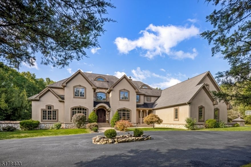 Custom true stucco Colonial, a serene presence 9.85 farmland assessed acres adjacent to Bedminster's network of bridle paths. A peaceful cul de sac, the location combines easy access to transportation with privacy and convenience for a gracious country lifestyle.Heated gunite SALT WATER pool & patio, a stunning bluestone terrace graced by granite balusters. A 2,300 square-foot barn for animals or extra cars. Level lotFloor plan of five bedrooms & four-and-one-half baths begins in a grand entrance foyer designed with curving walls & sweeping staircase. Sought-after features include multiple office spaces on first floor, expansive family and dining rooms, and an upscale center island kitchen.Gourmet kitchen- solid wood cabinets, a six-burner stainless steel gas range & hood, dual Sub-Zero refrigeration units, a new backsplash and granite-topped center island. Dining area open to family room. Both rooms connect to the terrace from French-style doors. Separate office/sitting room has glass doors for privacy. Gleaming wood floors, first floor au pair/in law bedroom w/ensuite bath,  mud/laundry room w dog washing sink, storage closets, front & back staircases.The primary suite has balcony, fireplace, sitting area  multiple walk-in fitted closets. The bath contains dual undermounted sinks, an oversized tiled shower, jetted tub & private water closet. 2 bedrooms are connected by a full bath, fourth bedroom w/ ensuite bath.Separate drive to masonry 2300 sq. dt barn; FLA as a wood lot.