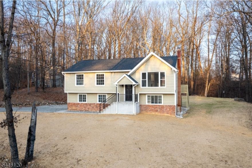 Welcome to a completely reimagined bi-level home offering nearly 2,300 sq. ft. of modern living space. This move-in-ready home features 4 bedrooms and 3 full baths, an open-concept layout with high ceilings, and abundant natural light throughout. The updated interior showcases modern finishes, stylish light fixtures, and a custom wine bar perfect for entertaining. Major upgrades include a brand-new roof and septic system, providing peace of mind for years to come. The versatile layout offers flexible living space ideal for extended living or guest accommodations. Enjoy outdoor gatherings in the spacious backyard, perfect for relaxing or entertaining. Conveniently located just minutes from shopping, dining, parks, and commuter routes with easy access to nearby Hackettstown and NJ Transit Hackettstown Line.