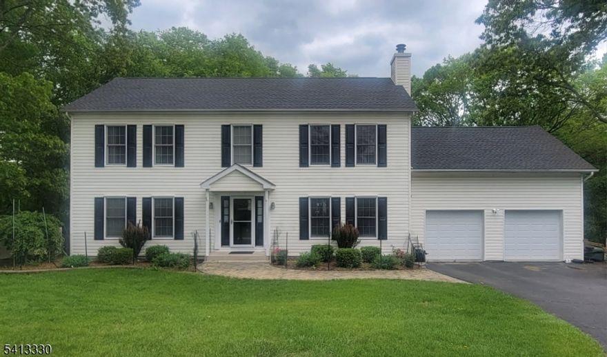 Welcome home to this beautifully maintained 3-bedroom Colonial, perfectly set on 1.25 acres of partially open land framed by mature trees, offering both privacy & a true neighborhood feel in a walkable community. Step inside to a spacious foyer with an open staircase that sets the tone for the thoughtfully designed interior. The heart of the home is the stunning, updated kitchen, featuring granite countertops, a center island, stainless steel appliances, and an inviting breakfast room that flows seamlessly into the expansive family room with a wood-burning fireplace. A formal dining room just off the kitchen adds the perfect touch for entertaining. Enjoy indoor-outdoor living with a deck off the kitchen, ideal for al fresco dining and entertaining while overlooking the private backyard. Upstairs, you'll find three generously sized bedrooms, two full baths, a convenient laundry area, and a bonus leisure room perfect for a home office, playroom, or media space. The primary suite is a true retreat, offering two walk-in closets, a vanity area, a luxurious soaking tub, a separate stall shower & toilet room. The full walk-out basement, partially finished, provides flexibility with space for an exercise room, recreation area, and workshop. Step outside to a paver patio with a built-in fire pit, creating an ideal setting for relaxing evenings outdoors. Additional highlights include a 4-bedroom septic system, owned propane tank & generator hook-up, offering both value & peace of mind.