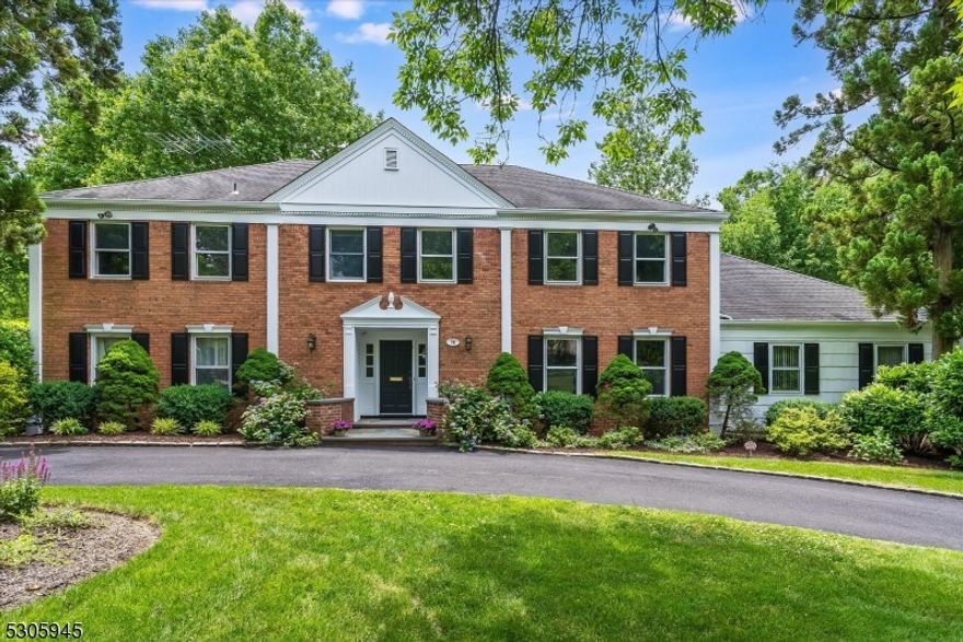This distinguished Center Hall Colonial residence epitomizes timeless elegance and sophisticated living. Graciously set on .56 acre, this stately home boasts expansive interiors designed for both entertaining and comfortable everyday living. A large foyer welcomes you and opens to generously proportioned formal living and dining rooms each flooded with natural light. The spacious kitchen, complete with a large center island and separate dining area, offers seamless access through sliding doors to an expansive deck overlooking lush greenery. An adjacent cozy yet generously sized family room features a floor to ceiling brick surround WBFP and expanse of windows providing a retreat for relaxation and intimate gatherings. Private, bright, and airy 1st-fl bedroom with newly renovated full bath. Upstairs hosts four bright large bedrooms, including a luxurious primary suite distinguished by its generous size, ample closet space and a versatile dressing, office, or exercise area. Lower level boasts an expansive multi-sectioned walk-out recreation area, with room for fitness, media and play catering to every lifestyle need. A private tree lined yard and the expansive deck create a seamless indoor-outdoor flow, perfect for enjoying serene mornings or hosting soirees under the stars. This distinguished property offers a rare opportunity to experience refined living, combining classic architectural charm with modern amenities for the discerning buyer seeking both elegance and comfort.