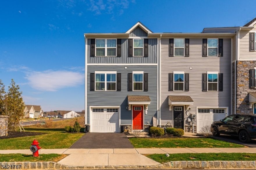 Welcome Home to luxurious community living Newly Built 2024 End-Unit Townhouse situated in highly sought-after Nature's Legacy section of Hawk Pointe Towns. Ground Level features large entry way including convenient Garage access, a Coat closet, and a BONUS Versatile space, Office, Gym, Family room, Recreation space. 2nd floor Enjoy an Open-Concept Floor with an upgraded Kitchen highlighted by gorgeous Quartz Countertops, Center Island, & Stainless Steel appliances that flows into a bright Living area and powder room. Sliding glass doors off the dining area lead to your private deck ideal for relaxing or hosting. 3rd floor features The Primary Suite includes an En-Suite Bathroom offering a Walk-In Shower and a custom spacious Walk-In Closet. Two additional bedrooms, a full main bathroom and a conveniently located laundry area complete this level. Home features Luxury Vinyl Plank flooring on the main and lower levels. End unit amplifies the abundance of natural light. Outdoor living at its finest offering a private setting with scenic views. Backyard & Side yard incredible for hosting & entertaining. A Commuters Dream with easy access to Route 31 and just a short drive to Route 22 and I-78.