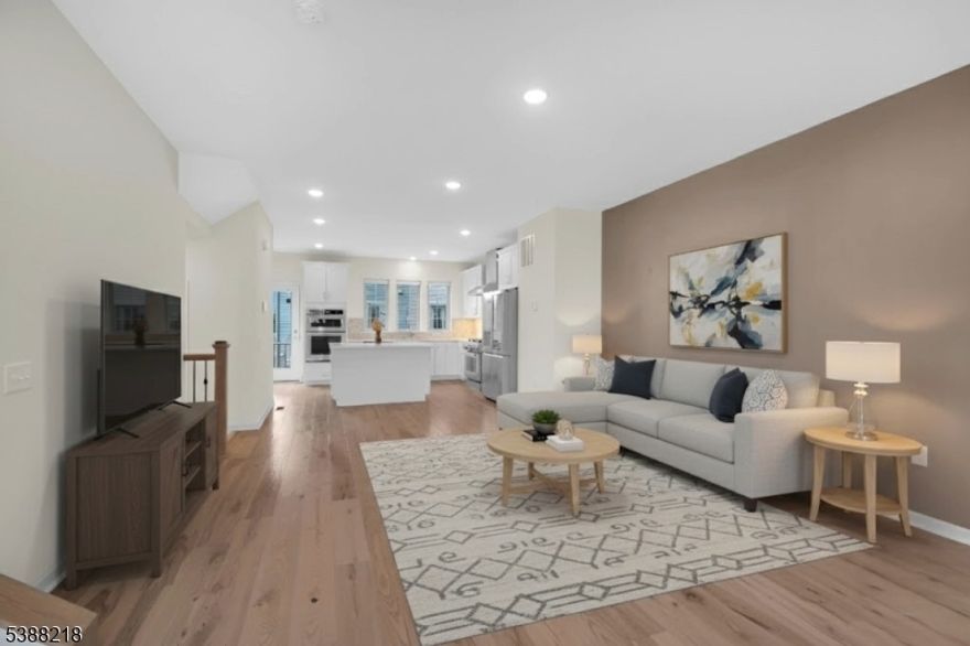 Experience luxury, comfort, and smart living in this beautifully updated end-unit townhome, ideally located in the prestigious Livingston Square community in Livingston, NJ. Set in a town known for its top-rated school system, upscale amenities, and easy commute to NYC, this sun-filled home offers the perfect blend of location, style, and convenience. Smart lighting, smart locks, and premium hardwood floors run throughout, creating a modern and welcoming ambiance. The open-concept gourmet kitchen is a chef's dream, featuring an LG Signature refrigerator, high-end appliances, upgraded cabinetry, sleek countertops, a powerful vent hood, and a pantry. Upstairs, you'll find two oversized bedrooms, each with its en-suite bath, including a luxurious primary suite with dual vanities and a custom walk-in closet. On the ground floor, the third bedroom also features a full en-suite bath and is outfitted with a state-of-the-art Murphy bed, built-in office desk, and custom storage. The garage is thoughtfully designed with epoxy floors, an EV charger, a bike hanger, a car-wash spigot, built-in cabinetry, and a custom workstation, all brightly lit for ultimate functionality. Meticulously maintained and move-in ready, this stunning townhome offers modern living in one of New Jersey's most sought-after communities.