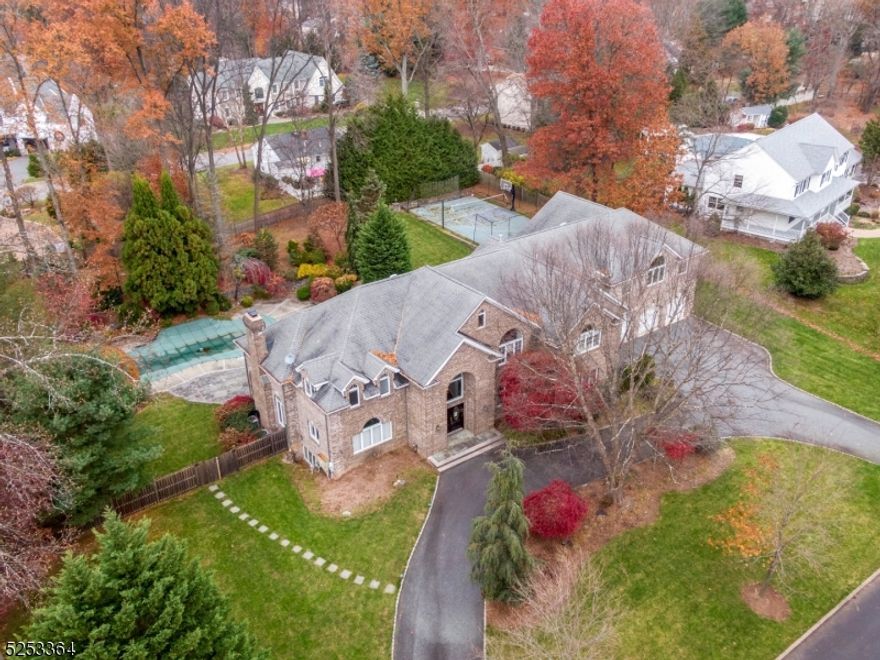 Simply Exquisite Old Tappan Residence! Offering you over 6300 sq ft of elegance throughout this home. The grand entry boasts a beautiful spiral staircase with chandelier, formal sitting room and formal dining room. First floor living room with accent custom stone wall adorning its cozy fire place overlooking the tastefully manicured yard  A custom kitchen with all the amenities you could dream of, including Cherry cabinetry, custom organization throughout, Stainless steel appliances, Viking Stove and full pantry. Features 5 bedrooms, 5 full baths.& first level powder room. Oversized Master bedroom Suite with Fireplace and balcony overlooking yard and an exceptional bonus of a full sized additional living area. 2 customized walk in closets. A beautiful master bedroom bath with oversized standup shower, Jacuzzi tub and Bidet. Perfect for entertaining with IG Pool and Basketball Court. Full finished basement with Summer kitchen, Full Bath, Rec Room and access to Yard. 4 car garage! This spectacular home has too many extras to list! Welcome home!