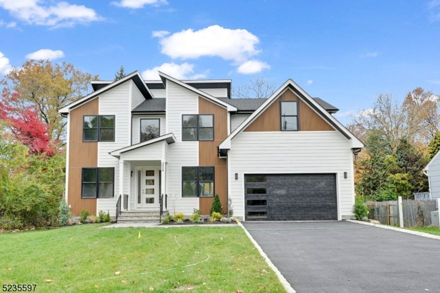 Gorgeous NEW CONSTRUCTION Contemporary Colonial home w 6BDs, 5.5BAs, 5,000+/- sf of finished living space over 3 floors & situated on a flat .34 acre lot. Enter the dramatic 2 story foyer w a sweeping staircase flanked by a formal DR w extensive millwork & Butler's Pantry & formal LR; making entertaining a breeze! Beautiful HW floors lead to an expansive Kitchen & Family Room w electric fireplace w tile surround; sliders to the paver patio overlooking the lush fully fenced backyard. The kitchen is complete w modern flat front light oak custom cabinetry to the ceiling, high-end SS appliances, large center island w coordinating quartz single-sided waterfall top, quartz countertops, Walk-in Pantry & first floor en-suite. The 2nd floor is home to 4 bedrooms including a gracious Primary Suite w a tray ceiling, enormous walk-in closet & spa-like bath w soaking tub, stall shower & dual sinks. One additional Bedroom is an en-suite, other two bedrooms share a full bath & Laundry Room for convenience. The Finished Basement w 9 ft ceilings is equipped w a Bedroom, private Office & large Rec Room w built-in bar w custom cabinetry & full Bathroom. SMART Home features include Nest, Ring, and EV Charger outlets.