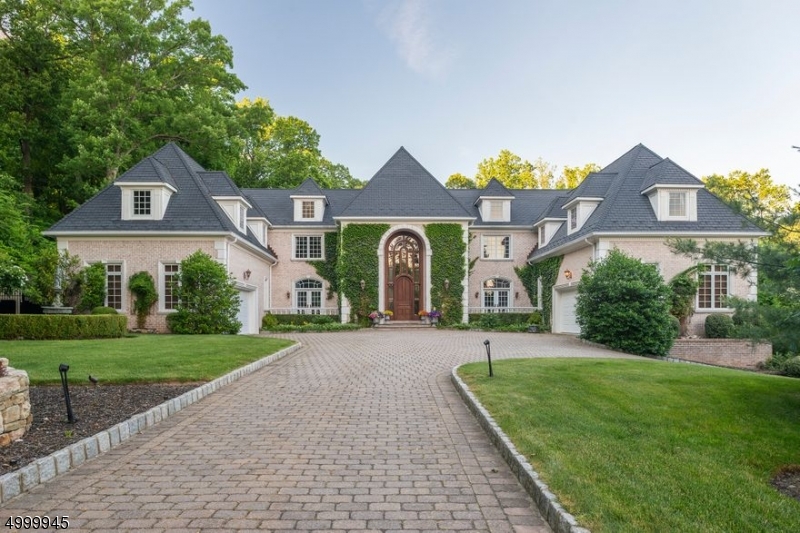 Exquisite French Manor Home, on 1.78 private, lush acres of captivating gardens. It offers masterful design, exceptional craftsmanship & superbly elegant detailing. Saltwater pool,  paver patios. Elegant foyer with hand crafted circular staircase, elevator.   Opulent Living and Dining Rooms for elegant entertaining. English style Library/office w/ fireplace, wet bar.   Coffered ceiling Family Room with fireplace, in law suite w/ full bath. Superior kitchen w/ casual dining area, center island.  Serene grand bedroom suite with fireplace, balcony, dual bathroom with two showers, fireplace, sitting room, adjacent office. Five additional ensuite bedrooms. Entertainment level with wine cellar,  workout room, office with full bath, entertainment room with fireplace and full bar, theatre. 3 two car garages.