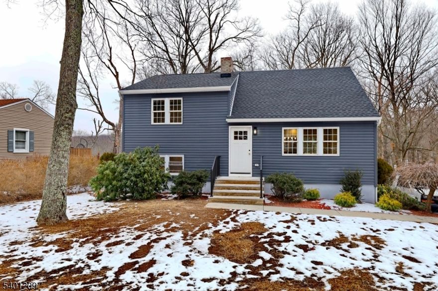 Modern fully renovated inside and out split level on an acre of the lot. Offers brand new septic system. Living room with electric fireplace, eat-in kitchen with ss appliances and island, slider door to the deck, 3 bedrooms and 2 full bathrooms, rec room, laundry and direct access to the yard. Central a/c, brand new windows, roof, hardwood floors, recessed lighting, 2 car garage. Enjoy open backyard with a entertaining deck!  Great location, stylish finishes this home is a must-see!