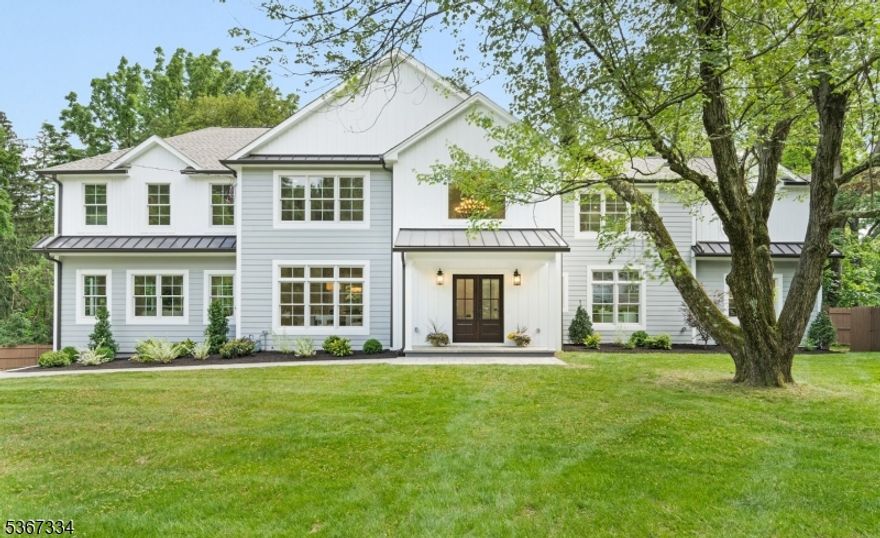 Step into timeless sophistication with this newly expanded 6-bedroom, 5 full bath luxury home, thoughtfully designed to blend elevated modern living with enduring quality. Every detail of this spacious home speaks to exceptional craftsmanship and refined style, from the hardwood floors to the 9' ceilings on the first floor and custom millwork throughout.  At the heart of the home is a chef's kitchen outfitted with top-of-the-line Frigidaire Pro Series appliances, quartz countertops, an expansive center island, and custom cabinetry designed for both everyday ease and elegant entertaining. A walk-in pantry complements the convenience and luxury. A light-filled living room is anchored by a gas fireplace and accented with beamed ceiling, adding character and warmth. The formal dining room boasts custom built-ins and a wine refrigerator, ensuring you don't miss a beat when entertaining. The family room offers large glass sliders to the patio and continues to a main-level en suite bedroom, offering flexible living or working space.  The upper level showcases a luxurious primary suite with spa-inspired bath, walk-in closet, tray ceiling, and tranquil ambiance. Four additional bedrooms, two sharing a dual access bath, provide comfort and privacy for all. The laundry room tops off the second level.  Additional highlights include a finished walk-out basement complete with two flexible rooms and a full bath. Your opportunity to own a masterpiece of modern design and fine living awaits.