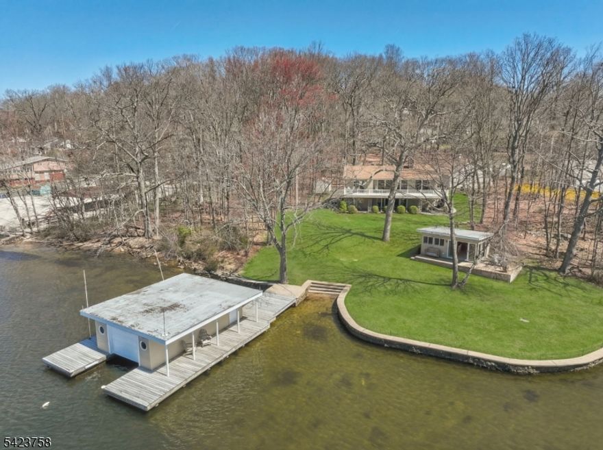 A truly unique opportunity to own a private, premier lakefront estate on the shores of Lk. Hopatcong, NJ's most coveted lake destination. Set on approx. 1.5 scenic, private acres with 340+ feet of prime lake frontage, this exceptional property is tucked away at the end of a quiet street - the perfect blend of serenity, space, & unparalleled lake access.  Featuring a custom 2-story home, a 3-car garage, a charming lakeside cabana & boathouse, all thoughtfully positioned on a gently sloping, level lot. Mature landscaping & expansive lawn create an ideal setting for recreation, entertaining, or peaceful relaxation. A sandy-bottom swim area provides enjoyment of the water directly from your own backyard. Soak in sweeping panoramic lake views from the impressive deck, perfect for hosting gatherings or enjoying tranquil mornings & spectacular sunsets. The primary homesite encompasses approx. 0.72 acres, offering both immediate comfort & future potential.  Enhancing the value of this offering is a separately 0.83 acre deeded level, wooded building lot located at 4 Maine Street - an rare opportunity for a guest cottage, private retreat, or future expansion. This is more than a home it's a lakeside lifestyle. Whether you're seeking a serene waterfront escape, a legacy property, or a rare investment opportunity, this estate delivers on every level. Enjoy boating, swimming, & 4-season recreation in one of NJ's most desirable lake communities. This is truly a once-in-a-lifetime offering.