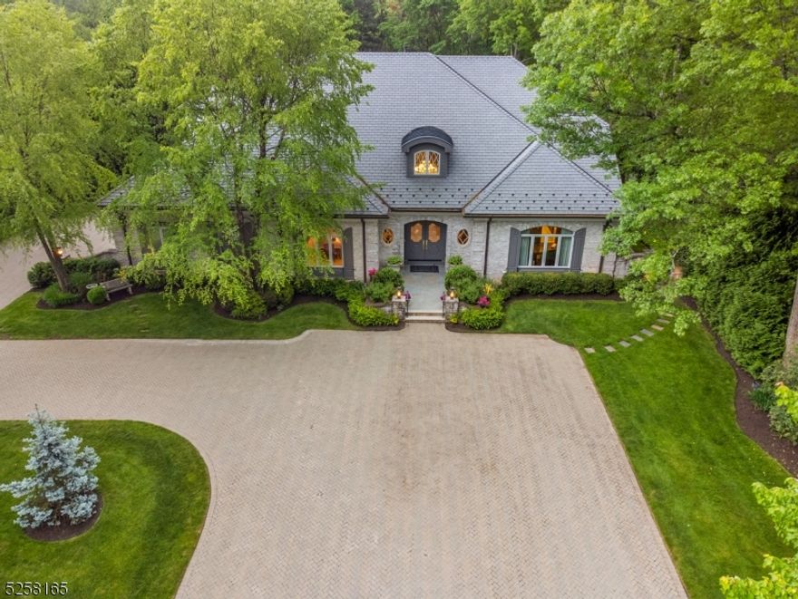 Custom built, all Brick Palatial French Manor ideally located on a cul de sac w/ saltwater pool, hot tub, new, cool limestone pool deck & summer kitchen - your own private oasis w/outdoor fireplace spanning 30' making this French Manor visually breathtaking. Grand 2-story entrance hall leads to magnificent living room w/soaring 2-story ceiling, FP, & French doors open to patio, pool & property. Banquet sized dining room & butler's pantry w/custom cabinetry & new wine refrigerator leads into stunning, gourmet EIK w/ custom cabinetry, top of the line Wolf & Subzero appliances & 2 sets of French doors open to patio. Incredible Family Room/Media Room w/ state of the art A/V equipment totally open to the kitchen. Handsome wood paneled home office w/ built-ins & gas FP. Primary Bedroom w/ gas FP & huge WIC. Every inch of the spa-like Primary Bath is onyx, & features radiant heated floors & 7' bathtub w/ Jacuzzi jets. Easy 1st level access to attached oversized, heated 3-car garage. 2nd level features 4+ bdrms w/ en suite baths + bonus room. Unfinished lower level w/ 10' ceilings, can accommodate golf simulator, wine cellar & rec room. Spectacular amenities: poured concrete foundation, new Da Vinci 50 year roof w/copper leaders & gutters, double driveway entrance, exterior landscape lighting, major investment in rear property, giant Norway Spruce Evergreen trees, Bevolo Lanterns, hydrangeas & perennials, black wrought iron gates provide privacy. New Generator & Smart house features.