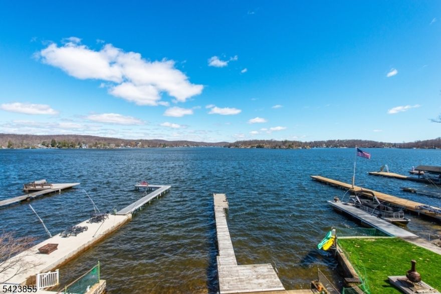 Enjoy the best of lakefront living in this beautifully located 3-Bedroom, 3-Bathroom waterfront home offering breathtaking main lake views.    Perfectly situated to capture stunning sunrise vistas, this home delivers the ideal balance of relaxation, recreation, and entertaining.  Step inside to find comfortable living spaces designed to maximize natural light and panoramic water views. The layout flows seamlessly to multiple outdoor entertaining areas, making indoor-outdoor living effortless.  Outside, enjoy a backyard leading directly to the water, perfect for gatherings, lawn games, or peaceful mornings by the lake. Expansive decks provide exceptional entertaining space, while your private dock offers easy access for boating, swimming, and lakeside enjoyment.   Being  sold as is.    Highest and best to be submitted by Thursday, April 23 at 5pmNote - 2-bedroom town approved septic