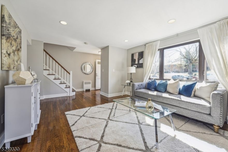 FULLY RENOVATED END UNIT 3 STORY TOWN HOUSE IN DESIRABLE TROY VILLAGE! Upon entering, you are welcomed home by gleaming hardwood floors, abundant natural light through the brand new windows, and the fresh scent of NEW. The kitchen has been completely renovated with quartz counters, marble herringbone backsplash, soft close shaker white cabinets, and New Stainless Steel appliances. Entertaining is a breeze in this open floor plan. Upstairs, you will find expansive bedrooms, each with their own private luxurious spa bathrooms. The master has 2 large walk in closets. The basement is fully finished with walk-out separate exit that leads directly to parking spot. Plenty of storage. Enjoy close proximity to Community pool, close to Direct NYC bus stop, and morning strolls in Briant Park.