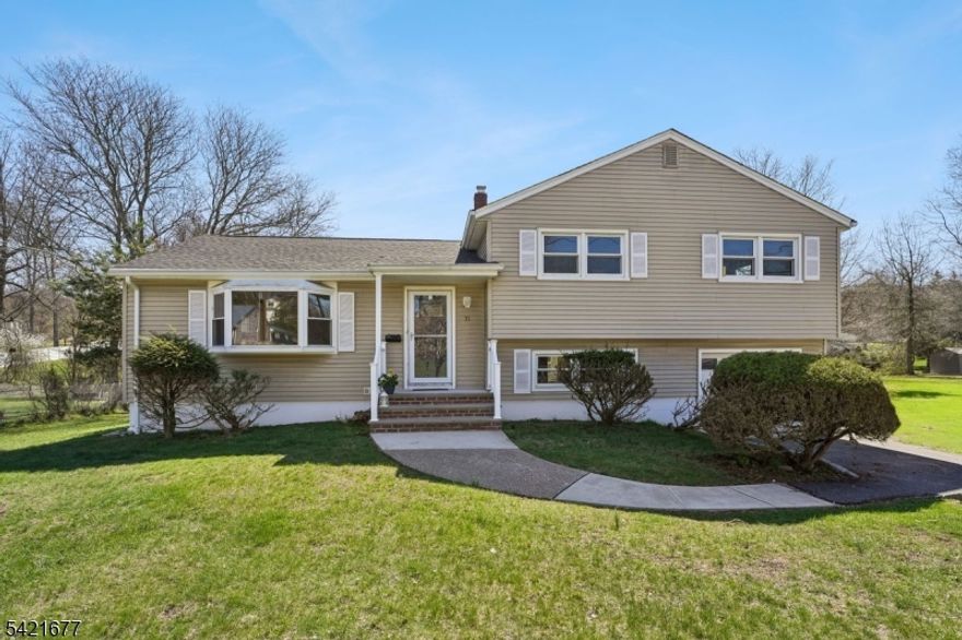 Welcome to this beautifully updated three-bedroom, two full bath split-level home in desirable Cedar Grove. Thoughtfully renovated home offers a perfect blend of comfort, style, and functionality. Main living area features gleaming hardwood floors and a spacious living room highlighted by stunning bay window filling the space with natural light. Living room flows seamlessly into the dining room, creating an ideal setting for everyday living and entertaining. Renovated kitchen offers modern finishes and a fresh, updated feel. A short flight of stairs leads to three generously-sized bedrooms, including primary suite with its own ensuite bathroom. A beautifully updated hallway bath serves the additional bedrooms. The lower level includes a cozy den, perfect for home office, and a large laundry room which provides convenient access to the backyard. An attached single-car garage with interior entry adds to the home's practicality. Situated on a lovely, level lot, the backyard has a small deck and plenty of space to relax, entertain, or enjoy outdoor activities. All of this in a fantastic location close to transportation, shops, and restaurants in both Montclair and Cedar Grove.
