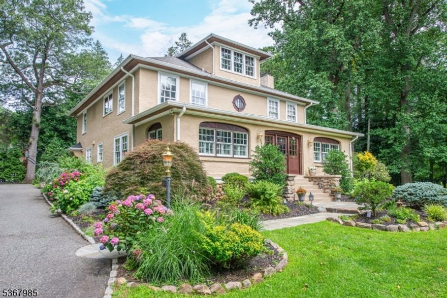 Welcome to this enchanting Hapgood colonial, perfectly situated on a picturesque 1-acre lot in the heart of town, directly across from scenic Wildwood Lake and conveniently close to schools and NYC transit. The beautifully landscaped grounds offer privacy and a spacious bluestone patio with a hot tub for outdoor relaxation. Inside, you'll find a blend of luxury and charm with unique architectural details. The chef's kitchen features Brazilian cherry cabinets and premium stainless steel appliances. The inviting family room, complete with a gas fireplace and wet bar, is ideal for entertaining, while the formal dining room with chestnut paneling is perfect for special occasions. A large LR w/ wood burning frpl. & a 4 season porch with wooded lake views add to the home's appeal. The second floor hosts a luxurious primary suite with a gas fireplace, tray ceiling, an opulent WIC alongside a sumptuous bath w/ heated floor. Additional bedrooms are generously sized, served by a hall bath w/ double vanity. The third floor offers a versatile fifth bedroom suite with a cozy library alcove and full bath. The LL incl. a rec. rm., office, craft room, half bath and utility space. The property also features a detached heated two-car garage with a finished second level for extra space. With meticulous maintenance and a whole-house generator for added security, this home is ready to provide comfort and serenity. Embrace the lifestyle offered by Mountain Lakes in this exceptional residence.