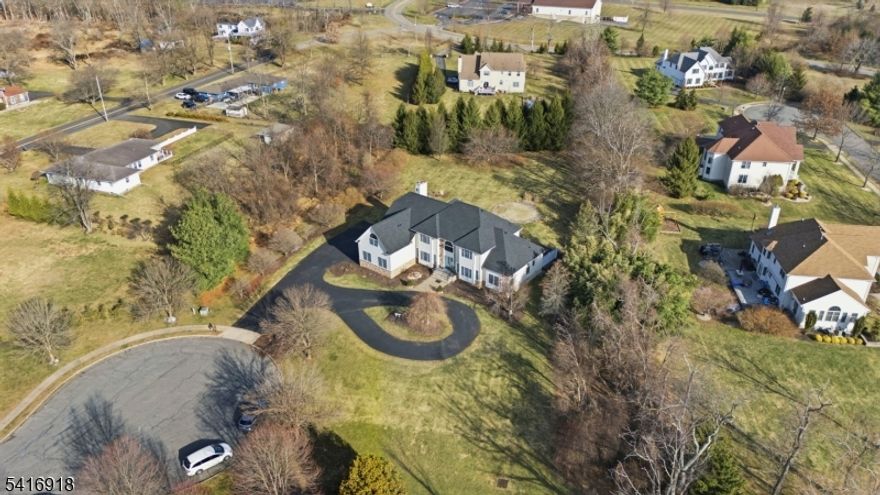 EXQUISITE COLONIAL HOME WITH NEW ROOF (2025). Set at the end of a quiet cul-de-sac on 1.33 acres, this 5BR, 5BA colonial blends elegance and modern functionality. A dramatic dual staircase one from the grand foyer, one from the family room creates a striking centerpiece. The first-floor in-law/guest suite offers a private bedroom, walk-in closet, and full bath, ideal for family or visitors. A dedicated first-floor office provides flexible workspace. The upgraded kitchen features granite countertops, modern appliances, new sink, and professional exhaust hood, flowing to a bright dinette and soaring family room that opens to a sun-filled sunroom.  Outdoor entertaining is effortless with a massive deck and patio overlooking the landscaped property. The partially finished basement adds versatile space for recreation, fitness, or future customization.Upstairs, the primary suite includes a spa-style bath with Jacuzzi and dual sinks. One bedroom offers an extended bonus room for a sitting area or additional office. Two bedrooms share a connecting bath, plus an additional bedroom and full bath. Additional highlights include main-level laundry, 3-car garage, and a grand circular driveway for 10+ vehicles. Located in a Blue Ribbon school district with access to Rt 12, Princeton, and Bridgewater. About 30 minutes to Trenton Airport and within an hour of EWR and PHL.  Experience refined living, entertaining with ease, and the perfect combination of style, comfort, and convenience.
