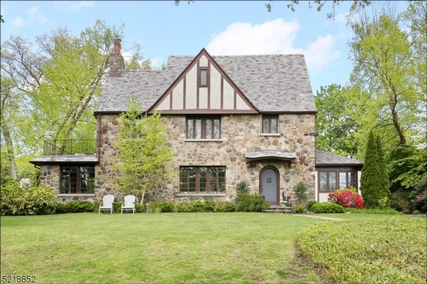 1920s Tudor is set on almost half acre in the Old Country Club neighborhood of Ridgewood. This home has been renovated and updated for today's lifestyle whilst retaining the fine architectural details of the period. Custom kitchen featuring Viking, Sub-Zero and Thermador Stainless Steel Appliances, including Sub-Zero wine cooler and Franke fixtures. Radiant heat in kitchen, mudroom and den. Architectural custom molding and trim throughout. Primary Bedroom Suite & Bathroom w/access to private balcony. Full finished Basement with a newly added full bathroom, gym, kitchenette, "hang out space" and lots storage. Full House Filtration System, security system, lighting and irrigation. Smart-home technology with surround sound wired for Sonos. Large fenced back lawn and bluestone patio.  Close to schools, houses of worship, shopping & easy NYC commute!