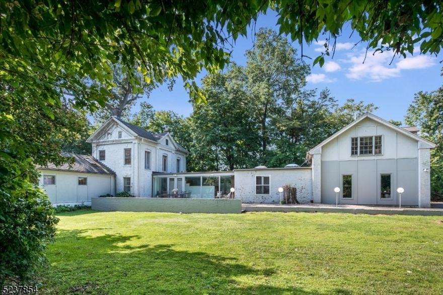 OFFER ACCEPTED, OPEN HOUSES CANCELLED--One of only 20 homes in the iconic Dellwood Park enclave in The Hill section of Madison, the sky's the limit in this serene one acre plus property nestled at the end of the cul-de-sac. Immerse yourself in this sanctuary where classic charm meets modern allure. This home features a large primary suite; an additional bedroom suite at the other end of the house that is ideal for guests, multi-generational suite, or au pair quarters; four additional bedrooms; six total bathrooms and myriad rooms to enjoy. Plus LOW TAXES! Enter the property through a lush private drive to discover a home like no other. Surrounded by old growth trees with views of "The Dell", the original brick Colonial was built in the mid-1800's as part of the Houghmont Estate, the original home in this neighborhood. The house was artfully expanded in the mid-1960's by then Owner/architect Peter Drake, in the Usonian style. This "glass gallery" expansion was featured in the 1965 H&G Remodeling Guide showing how "skillful use of materials can unify the old and the new." Renovations in further years continued this spirit of invention and preservation to create the large (approx. 4000 sq ft per seller), unique space you'll discover today. Be the next visionary to put your stamp on this treasured home! Come visit this remarkable property in the most sought after section of the town voted one of the best in New Jersey. Your prize awaits.