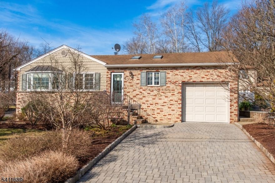 Welcome to Summit! This beautiful three-bedroom, 2.5-bath brick ranch sits on a desirable corner property and offers a finished basement for additional living space. The spacious 30' x 13' family room features skylights, hardwood floors, open concept to the kitchen and dining room and also has french doors that lead to a wraparound trex deck and bluestone paver patio with a pergola perfect for relaxing or entertaining overlooking the fenced yard. The kitchen boasts a large center island with a granite countertop and stainless steel appliances,there is a formal living room with loads of sunshine and 3 bedrooms all with oak flooring,main bedroomw/vaulted ceiling complete this level   The basement boast a kitchenette, lots of storage and a dry bar!  There is a generator hook up. Don't miss the opportunity to see this wonderful home schedule your showing today!