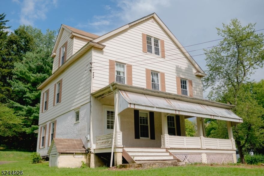 This charming colonial sits high up overlooking the parklike double lot. Relax and take in the peaceful views on the huge covered wrap around front porch. The woodwork and craftsmanship throughout this home add classic charm. Large formal dining room, living room and family room.  Plumbed for a second full bathroom on the third floor.  Large storage shed. Tremendous potential to add value on this beautiful home or move right in and make it your own.