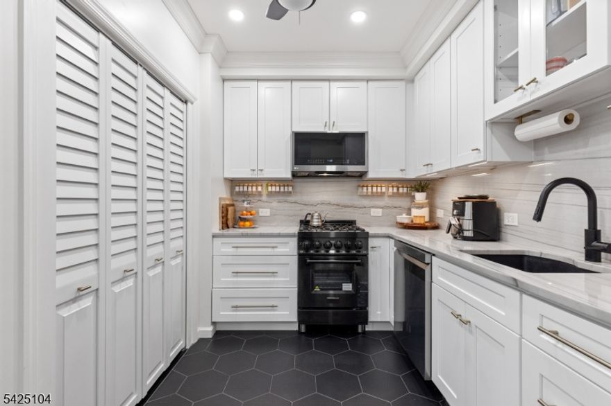 Private patio living in the sought-after Hamilton Park area of Downtown Jersey City, this beautifully renovated two-bedroom home combines modern upgrades, classic architectural charm, and an exceptional location just moments from all Jersey City offers. Situated on the first floor of a well-maintained boutique three-unit pet-friendly building, this thoughtfully designed residence offers approximately 851 sqft of comfortable living space along with a private covered patio featuring a retractable awning and lighting - perfect for outdoor dining, entertaining, or relaxing. The designer-renovated kitchen showcases quartz countertops, white shaker-style cabinetry, subway tile backsplash, under-cabinet lighting, stainless steel appliances, and striking black hex tile flooring.A brand-new in-home washer and dryer adds everyday convenience. The bright living and dining areas feature bay windows, crown molding, recessed LED lighting, and dark-stained hardwood floors. Both bedrooms are well-proportioned, with the primary bedroom offering a custom closet system. The second bedroom works perfectly as a guest room or work-from-home office.The bathroom has been tastefully updated with classic white subway tile and a Carrara marble-top vanity. Additional highlights include efficient mini-split heating and cooling, ceiling fans, and a large under-stair storage closet. For added buyer confidence, the seller will provide a one-year home warranty through Assurant at closing. Welcome Home!