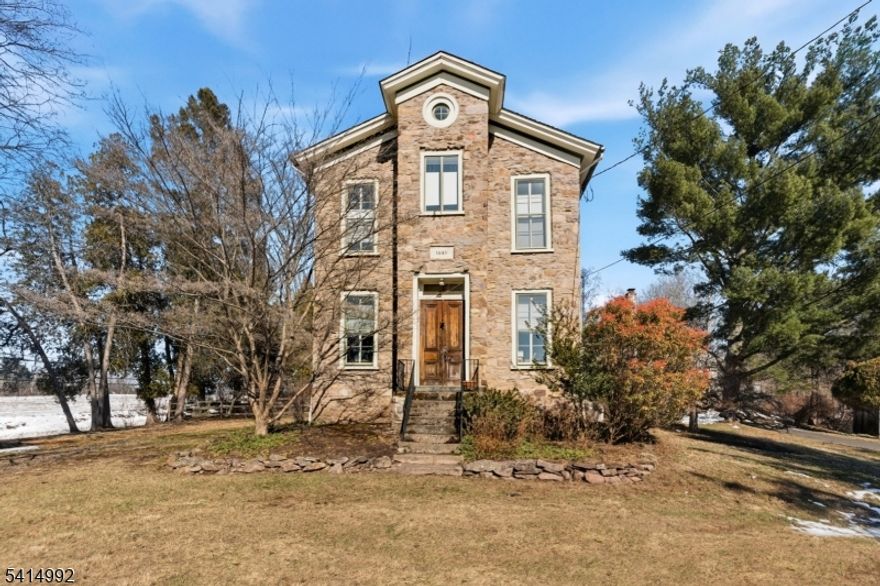 Perched above the charm of Stockton, this extraordinary home offers a peaceful retreat just moments from town. Surrounded by 1.94 acres of extraordinary natural beauty, this remarkable stone residence offers a rare opportunity to experience a quieter, more intentional way of living just a scenic drive from both New York and Philadelphia. Steeped in history and rich with character, the home's thick stone walls, deep-set windows and soaring 12-foot ceilings create a sense of authenticity that is nearly impossible to replicate. Modern comforts, including central air conditioning & a whole-house generator, ensure effortless year-round living. From the kitchen, peaceful views unfold across the private stone patio and gardens beyond, while a hidden wine cellar, accessed by a spiral staircase tucked discreetly within, adds an element of surprise. The home offers three bedrooms and two and one-half baths, including a tranquil primary suite with its own ensuite bath. A 2nd-floor laundry adds everyday convenience. The grounds feel both expansive and intimate, with mature trees, open lawn and a heated in-ground pool creating a private retreat that invites both relaxation and gathering. Adding exceptional versatility, the fully equipped guesthouse is currently generating income and offers endless possibilities whether for hosting, creating a private studio, or continuing as an investment. Located near acclaimed dining and access to the Delaware River's scenic beauty.