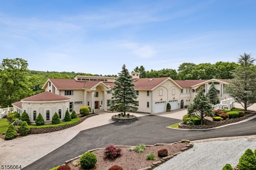 Offering a world of luxury, comfort, and prestige, Sparta Mountain Estate encompasses beautifully scaled rooms and large spaces for entertaining both inside and out. Situated on a private lake and 5.84 acres, with a gated entry and a European modern flair design, this house is sure to impress! As you step inside the home you will be greeted with a dramatic entryway adorned with a Crystal chandelier and magnificent floor to ceiling windows that overlook the private lake. Whether you are looking to watch a movie in one of the two cinemas, swim in the resort style indoor or outdoor pools, get a massage in the private spa room, entertain in the wine cellar, or take some time in the music room, this house has it all! Throughout the estate you will continue to be impressed with many amenities including an elevator with access to all levels, 2 extensive garages that hold 13 cars, as well as multi generational quarters.  Come experience the magnificence of Sparta Mountain Estate! A spectacular, private resort setting "One of a kind"!  A unique Opportunity to become a part of a very exclusive Lake Community which also includes secured Membership in the Lake Mohawk Country Club!