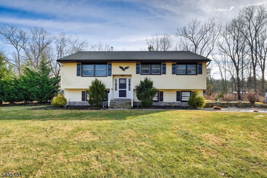 Immaculate 4-bedroom, 3 full bath bi-level in Warren Township. This beautifully maintained home offers a rare combination of high-end finishes, thoughtful layout, and move-in-ready perfection.The sun-drenched main level features gleaming hardwood floors and recessed lighting throughout. At the heart of the home is a stunning, fully renovated kitchen with crisp white shaker cabinetry, sleek black granite countertops, designer tile backsplash, stainless steel appliances, and a large center island with seating. The kitchen opens seamlessly to the spacious living room, anchored by a cozy freestanding fireplace.Just off the kitchen and dining area, sliding doors lead to a private deck overlooking the backyard, creating an ideal indoor-outdoor flow for grilling, relaxing, or hosting guests.The main level offers a peaceful primary suite along with two additional bedrooms, all featuring hardwood floors, ample closet space, and a clean, modern aesthetic.The lower level adds exceptional versatility, offering a 4th bedroom, large family room or home office area with a second freestanding fireplace, a full bath, and a beautifully designed mudroom with built-in cubbies, bench seating, and coat hooks.Additional highlights include a two-car garage and a clever built-in Murphy bed area ideal for guests or flexible use.This is the rare Warren home that truly checks every box   layout, style, condition, and location   all in one exceptional property.