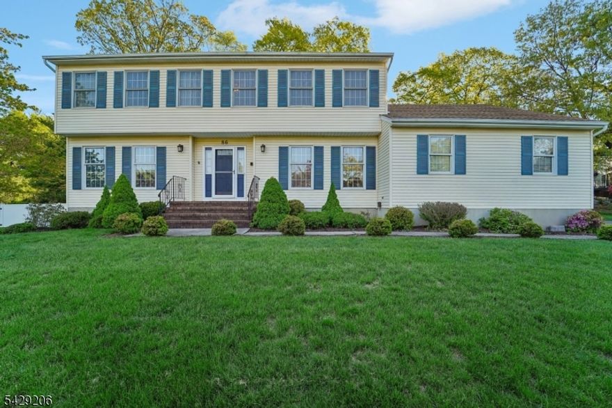 Welcome to this beautifully maintained 5-bedroom, 3-bathroom Colonial set on a manicured lot in sought-after Oak Hill Estates. A spacious entry foyer offers a warm and inviting introduction to the home's thoughtfully designed layout. The sun-filled living room provides a bright, comfortable setting for both everyday living and entertaining, while the adjoining family room creates the perfect space for relaxation and gathering. A wide cased opening connects the formal dining room to the eat-in kitchen, complete with custom cabinetry, granite countertops, stainless steel appliances, and a large center island. Sliding glass doors lead to the rear deck, offering seamless indoor-outdoor flow. The main level also features a full bathroom and a first-floor bedroom, ideal for guests, extended living, or a home office. Upstairs, the primary suite offers a generous closet and private en suite bath, complemented by three additional bedrooms and a full hall bathroom. The fully finished basement expands the home's versatility with a summer kitchen, den, and additional flexible living space. Enjoy outdoor entertaining on the rear deck overlooking the spacious backyard. A two-car attached garage and ample driveway parking add everyday convenience. Ideally located on a quiet residential street with easy access to NYC transportation, shopping, and dining, this home offers the perfect balance of comfort, space, and location.