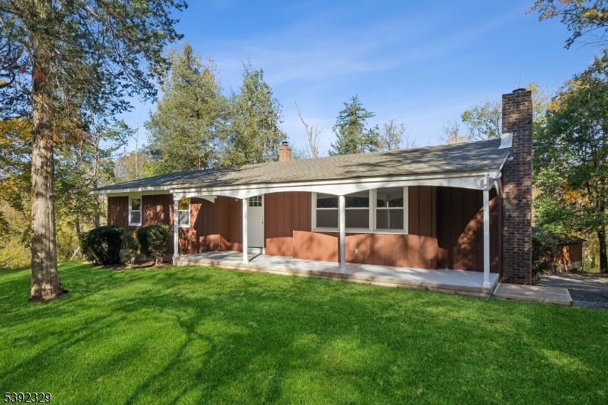 Discover this stunning ranch retreat nestled in the mountains near Round Valley Reservoir, offering the perfect blend of modern luxury and serene country living. Set on 5 tranquil acres with a peaceful stream winding through, this property is a true nature lover's paradise.  Beautifully and completely remodeled, including new roof, this home features a gorgeous new chef's kitchen with quartz countertops, brand-new stainless steel appliances, and an open layout ideal for entertaining. Gleaming wood flooring flows throughout, leading to spacious living areas filled with natural light. The bathrooms are beautifully remodeled, showcasing elegant finishes and timeless design. Enjoy your morning coffee on the open front porch or relax on the large enclosed porch overlooking your private landscape. The ground floor offers ideal in-law suite potential, complete with a separate entrance, living room, bedroom, kitchenette, and full bath. Car enthusiasts will appreciate both an attached two-car garage and a detached two-car garage.  Experience privacy, space, and scenic beauty just minutes from major highways, the NYC train line, local shops, and fine restaurants. Outdoor enthusiasts will love being near Round Valley Reservoir for hiking, biking, and fishing, as well as Stanton Ridge Golf and Country Club for recreation and social living. A rare opportunity to own a turnkey home in one of the area's most picturesque settings.