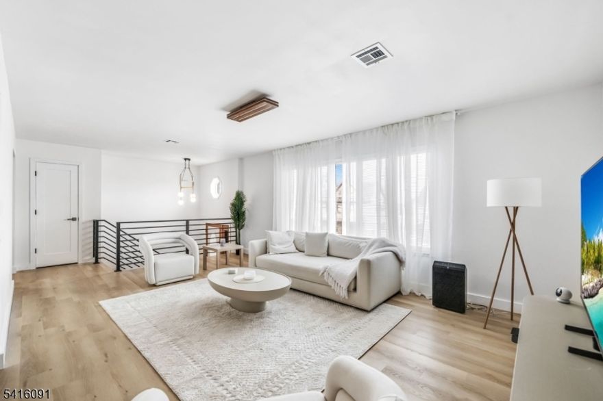 Welcome to this turnkey two-family in Garfield with extensive recent upgrades throughout. This fully refreshed property offers two spacious units and is ideal for an owner-occupant or investor looking for a move-in-ready home with income potential. The upper residence features a spacious 3-bedroom, 2-bath layout designed for comfortable living and effortless entertaining. Sun-filled living spaces flow seamlessly into the kitchen, now equipped with brand-new appliances and enhanced by clean, modern finishes highlighted by a fully updated bathroom finished with elegant porcelain tile. The primary suite offers a private updated en-suite bath and deck access, creating a comfortable retreat within the home. The second residence offers a well-appointed 2-bedroom, 1-bath layout. The unit provides a generous living space and an updated kitchen featuring all-new appliances. Extensive improvements throughout the home include newly installed air conditioning in both units, new LVP flooring, recessed lighting, fresh interior paint, and brand-new appliances, creating a crisp and contemporary aesthetic across the entire property. An even bigger bonus- both units have in-unit laundry as well as access to the two-car garage. Ideally located near parks, shopping, schools, and public transportation, this property combines everyday convenience with long-term versatility. This fully upgraded two-family home offers both comfort and opportunity in the heart of Bergen County