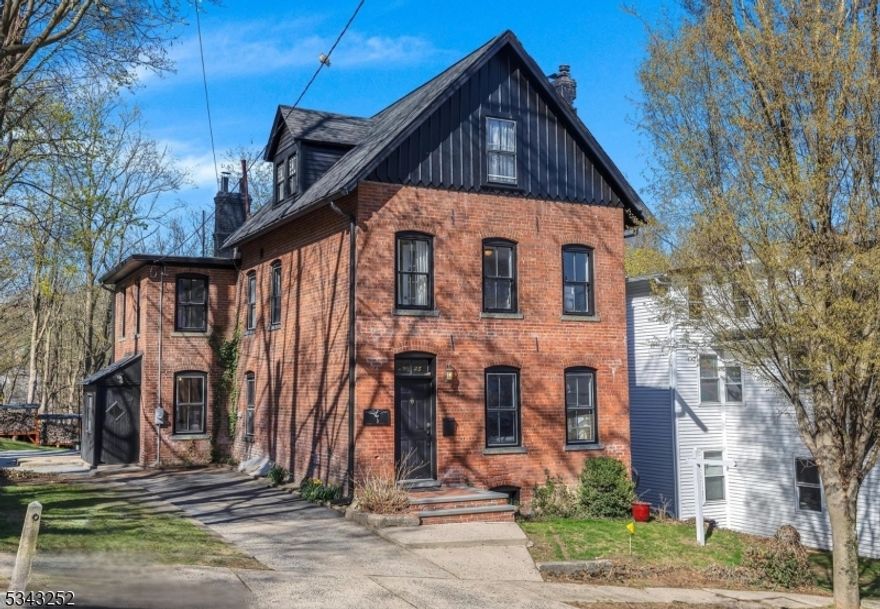 This elegant brick colonial in the heart of desirable Morristown is ready to be yours! Each update was thoughtfully finished with attention to craftmanship, historic details, and modern use. You'll love the beautiful wood floors throughout and the fully renovated kitchen is a cook's dream with a large island, fabulous antique-like gas stove, wood cabinets, shelving, and side entry to the driveway. The main level also has living and dining rooms, an office, a tucked away cute powder room, two staircases, an updated rear sunroom with a new glass door to the composite deck, paver stone patio, and a bonus deck in the backyard. On the second level, the fully renovated full bath compliments the four updated bedrooms. The third level has two bedrooms and a gorgeous brand-new full bath with skylights. The basement is freshly painted, electrical wiring has been updated, and the gas furnace was added in 2016. Enjoy living in Morristown with walkable streets, restaurants, shops, NJ Transit Midtown Direct train, world-renowned hospital, parks, and historical sites.