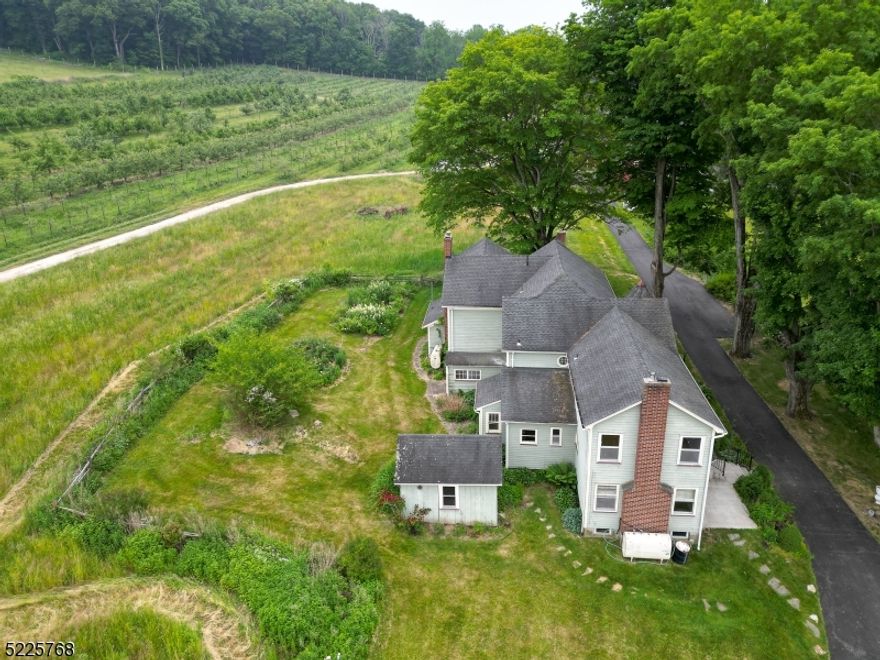Welcome to this delightful 2-bedroom, 2.5-bathroom Victorian Home nestled within a sprawling apple orchard on over 100 acres. As you approach the property, you'll be captivated by the picturesque surroundings, with rows of apple trees that create a stunning backdrop. This home is a gardener's dream. The exterior of the home boasts alluring Victorian architecture, showcasing intricate detailing and a charming front patio perfect for enjoying the serene views. Upon entering, you'll be greeted by a spacious and light-filled living area. The large rooms are filled with natural light, thanks to the large windows that allow the beauty of the orchard to seep indoors. Upstairs, you'll see the renovated full bathroom and added laundry room, adding modern amenities to the traditional Victorian charm. This home boasts an abundance of storage space, including a garage, basement and storage shed. Enjoy the best of rural living while being conveniently located within reach of local amenities, restaurants, and shopping centers.