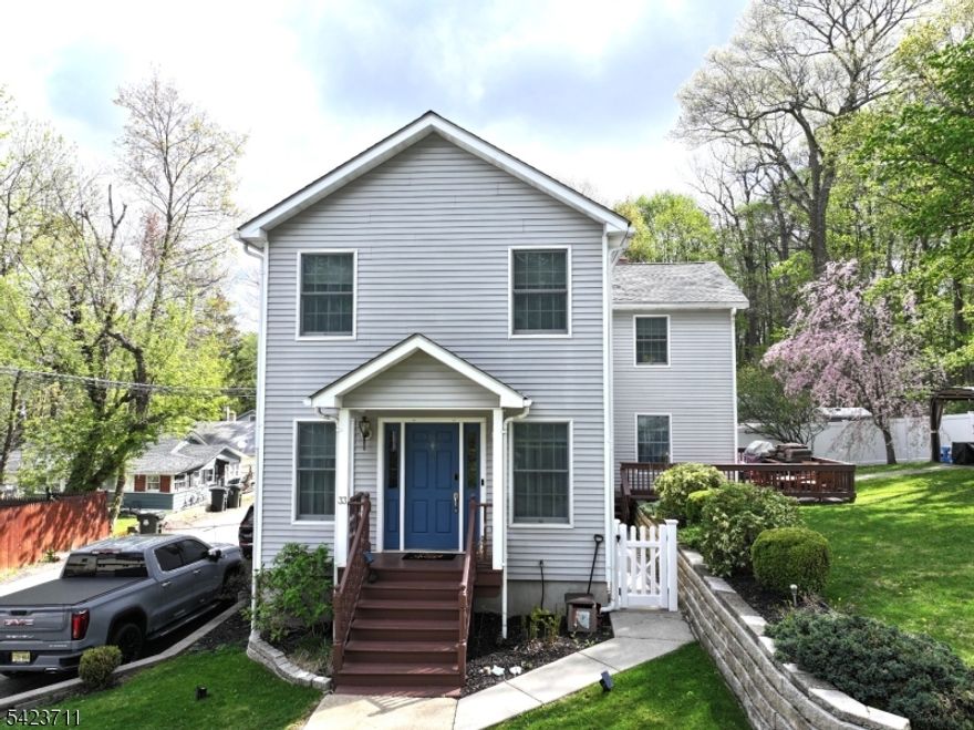 Welcome to this spacious Colonial nestled in the highly desirable Budd Lake area of Morris County, offering beautiful lake views and a lifestyle of comfort and convenience. Ideally located just minutes from shopping, dining, and major commuting routes, this home blends tranquility with everyday accessibility.Step inside to discover a bright and inviting open floor plan, perfect for both entertaining and daily living. The updated kitchen features granite countertops, ample cabinetry, and a convenient pantry closet, flowing seamlessly into the expansive family room and dining area.The main level also includes a generously sized living room highlighted by a stunning stone fireplace and sliding glass doors that lead to a large deck ideal for relaxing or hosting gatherings overlooking a level backyard.Upstairs, you'll find four generously sized bedrooms and a full bathroom, offering plenty of space for a variety of living needs. A first-floor laundry room and powder room add to the home's functionality and convenience.With its desirable location, scenic views, and flexible layout, this home offers something for everyone whether you're looking for space to grow, entertain, or simply enjoy picturesque views in a prime Morris County setting.