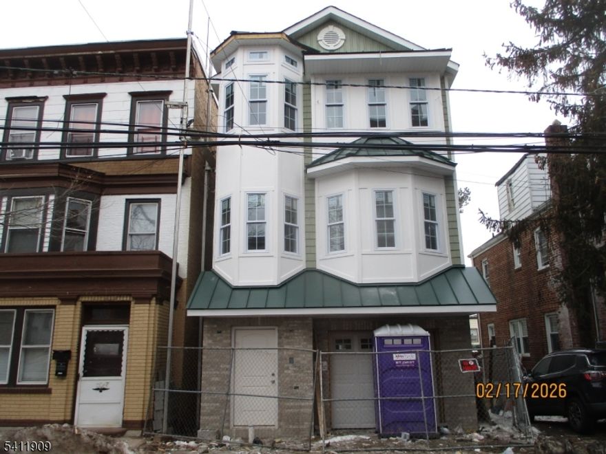 The "Aiden" model in the Vailsburg section of Newark's west ward. 3,819 square feet of luxury living space. Owner's unit (first and second level) features 3 bedrooms, 2.5 bathrooms, living room, dining room, eat-in-kitchen, as well as a large recreation room behind the 2-car built-in garage. The second unit (third level) offers 3 bedrooms, 2 full bathrooms, living room, dining room, and eat-in-kitchen. Premium oak hardwood and ceramic tile flooring throughout. Granite counters in all kitchens and bathrooms. Four-piece stainless steel appliance package in both kitchens. Central air conditioning and forced air heat on all levels of home. Home is eligible for 5 year property tax abatement. Floor plan can be found in media section.