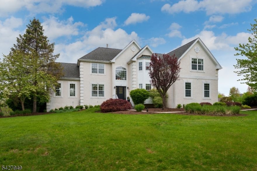 In the Estates of West Amwell, this original model home showcases the finest details and upgrades expected of a builder's showpiece home. Thoughtfully designed bump-outs enhance both space and light, while an extraordinary finished lower level elevates entertaining to an art form. Complete with a full bar, kegerator, full-size refrigerator, ice maker, microwave, and a full bath, this level opens through sliding doors to a resort-style pool and a sheltered patio with a mounted television. The gracious floor plan offers both front & rear staircases, four bedrooms, four full baths, and an additional powder room. Elegant formal living and dining rooms flow effortlessly into a sunlit conservatory, creating an ideal setting for both intimate gatherings and larger celebrations. The kitchen is equipped with double ovens, gas cooking, and a welcoming breakfast area, all opening to an expansive composite deck that overlooks the beautifully appointed outdoor spaces. Everyday living is equally well considered, with a spacious laundry room that provides direct access to a three-car garage, the powder room, and a home office. The primary suite features a tray ceiling, a separate sitting room, oversized W-I closet, & private bath. BRs 2 & 3 share a well-appointed Jack & Jill bath, while the 4th BR has its own private bath. Generous closets throughout complete this exceptional home, offering both style and substance in one of the area's most desirable communities near Lambertville/New Hope.