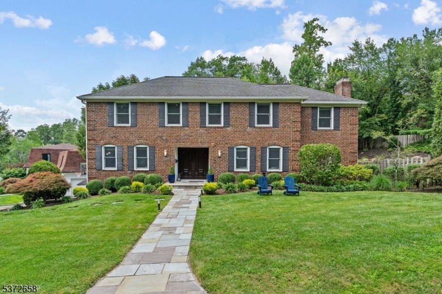 Beautifully maintained brick-front Colonial in a highly sought-after Short Hills neighborhood, just blocks from top-rated Deerfield Elementary. Blending timeless style with today's modern comforts, this home offers an open layout ideal for easy living and entertaining. Enter through a stone walkway and double doors into a welcoming foyer with hardwood floors and coat closet. The living room features hardwood floors and the spacious family room boasts two exposures of windows. Front-to-back dining room with a wood-burning fireplace and sliding doors to the backyard. Updated chef's eat-in kitchen shines with granite countertops, stainless steel appliances, custom cabinetry, built-in desk area and double sliding doors next to powder room opening to an oversized deck with built-in seating overlooking the private, tiered, fenced-in yard. Upstairs, the primary suite impresses with high ceilings, abundant storage including a walk-in closet + spa-like bathroom with double vanity, oversized shower and jacuzzi-style tub. 3 additional bedrooms, each with generous closets and natural light, share 2 full hallway bathrooms. Convenient 2nd floor laundry room adds ease to everyday living. Finished lower level provides a large recreation room, exercise area, office nook, multiple closets for storage, utility room, and direct access to attached 2-car garage. Perfectly located near NYC midtown direct trains, downtown Millburn, the Short Hills Mall and major highways.