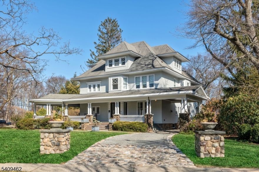 A truly rare offering in the heart of Ridgewood, 317 Prospect is a remarkable pre-war Colonial Revival that feels like a private compound. Set on a sprawling acre of beautifully landscaped grounds, this stately residence blends vintage charm with thoughtful modern updates, creating a 7-bedroom, 4.5 bath home that is both grand and welcoming. The main house offers generous, sun-filled living spaces designed for both everyday comfort and elegant entertainment, with multiple areas to gather, retreat, and spread out. Appreciate amenities such as the covered front and back porches, the sweeping, gallery-style staircase, the well-appointed gourmet kitchen, and the 30-foot great room. The carriage house adds to the home's exceptional appeal. In addition to three garage bays, the upper level features an incredibly versatile space ideal for a home office, studio, or gym. The grounds also feature a crushed and cobble stone driveway, automatic gate, and enclosed dog run. What truly sets this property apart is its rare combination of privacy and connected lifestyle. Just moments from Ridgewood's vibrant downtown, you can easily enjoy an early morning coffee run, acclaimed restaurants, boutique shopping, parks, schools, and the train to NYC all while returning home to the peace, space, and seclusion of an acre-sized setting. This is not just a home, it's a once-in-a-generation opportunity to own a truly special and irreplaceable property in Ridgewood. Owner holds NJ real estate license.