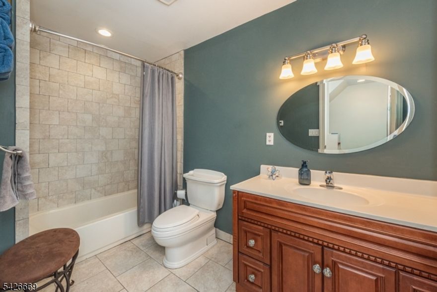 Gorgeous fully renovated home offering an open, airy floor plan and completely updated throughout. The stunning kitchen features an extra large center island and flows seamlessly into the main living and dining areas, perfect for everyday living and entertaining. A convenient 1st floor bedroom adds flexibility for guests. Enjoy a luxurious primary suite with a huge custom closet and a spa-like primary bath featuring an oversized shower with dual waterfall shower heads. Additional highlights include radiant heat, a large pantry, finished basement providing extra living space, a walk-up attic offering excellent storage or future potential, and an impressive 9-zone heating system for ultimate efficiency and comfort. The home is equipped with an on-demand water heater and thoughtful upgrades throughout. Step outside to a large deck, ideal for relaxing or hosting. Close to shopping, highways and NYC transportation. A true move-in ready home with exceptional attention to detail.  Square footage is 2818 as per town records
