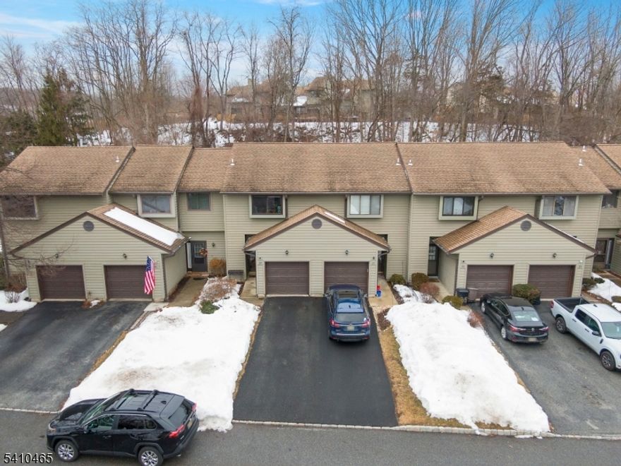 Welcome to desirable Hampton Commons in sought-after Hampton Township. This multi-level townhome offers a spacious layout with great bones and the opportunity to make it your own.A marble foyer leads to the open floor plan with Pergo flooring. The living room features a marble-framed corner wood-burning fireplace with oak mantle, vaulted ceilings, and sliding glass doors to the expanded deck. The deck is ideal for relaxing or entertaining and includes a direct gas line hookup with the grill included.The eat-in kitchen offers a pass-thru to the dining area. A brand new stove and over-the-range hood are scheduled for installation on 2/18/2026.Upstairs, the generously sized primary bedroom provides ample closet space and access to the full bath. A loft overlooking the living room offers flexible space for a home office, reading area, or guest overflow.The finished basement adds valuable living space for a recreation room, gym, media room, or additional living area. The lower level also includes the laundry area, utilities, new water heater (2025), new dryer (2025), and an owned water softener. A one-car attached garage and driveway parking add convenience.Residents enjoy community amenities including an in-ground pool, clubhouse with fitness area, playground, basketball, tennis, and pickleball courts. Minutes to shopping, dining, commuter routes, and all Sussex County has to offer.