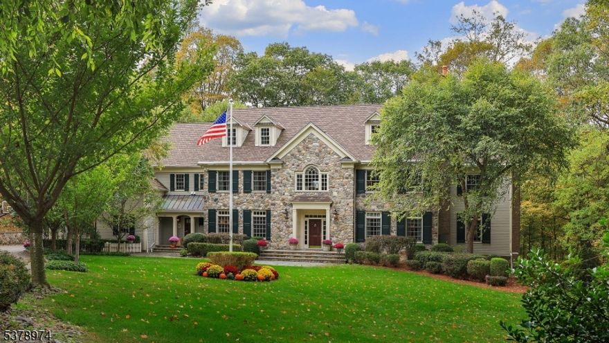 Nestled on over 7+ acres in a tranquil cul-de-sac, this exquisite Bernardsville estate blends timeless elegance with modern luxury and exceptional craftsmanship. A grand two-story entry showcases elegant marble flooring with mosaic tile and spacious coat closets. The living and dining rooms feature rich hardwood floors with decorative inlays, sophisticated tray ceilings, and custom millwork. The gourmet kitchen offers custom wood cabinetry, granite countertops, Viking and KitchenAid stainless steel appliances, and a large center island with breakfast bar. Enjoy seamless indoor-outdoor living through the vaulted breakfast room with French doors to the terrace. The family room impresses with a coffered ceiling, hand-painted gold foil dome, mahogany fireplace, and floor-to-ceiling windows leading to both patio and deck. The home boasts multiple luxurious bedrooms with ensuites, a custom library with cherrywood detailing, and a powder room with marble finishes. Entertainment is elevated with a handcrafted cherrywood bar, recreation room, exercise room, and a professionally designed home theater with stadium seating and state-of-the-art soundproofing. Outdoors, relish the heated Gunite pool and spa, koi pond with waterfall, bluestone terrace, IPE wood deck, and meticulously landscaped perennial gardens. Convenient to schools, shopping, and NJ Transit, this exceptional residence offers unmatched privacy, beauty, and comfort for refined living.