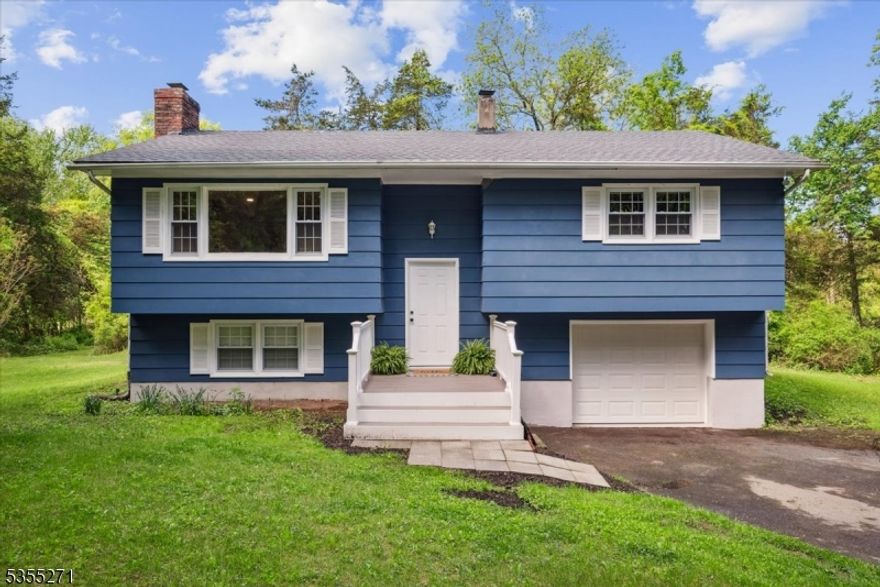 Welcome to your peaceful, move-in-ready country retreat! Nestled on over 1.5 acres of picturesque land, this charming bi-level home offers the perfect blend of comfort & modern updates. On the main level, you'll find 2 spacious bedrooms, 1 renovated full bathroom & kitchen boasting modern finishes & ample counter space with easy access to the formal dining room. The sunny living room highlights a stunning floor-to-ceiling brick wood-burning fireplace, adding warmth & character. Completing this level is an inviting 3-seasons room off the formal dining room, offering scenic views to the wooded backyard landscape, perfect for morning coffee or evening gatherings. On the ground floor, you have a 3rd bedroom, renovated half-bath, & dedicated laundry room just off the oversized 1-car garage. Additional highlights include a brand-new roof, new front porch/back steps & new carpet on the ground level. Enjoy the tranquility of country living with the convenience of thoughtful upgrades. This home offers the best of both worlds: peaceful surroundings with stylish comfort. Don't miss out on this rare opportunity!  Photos + Floor Plans are up!