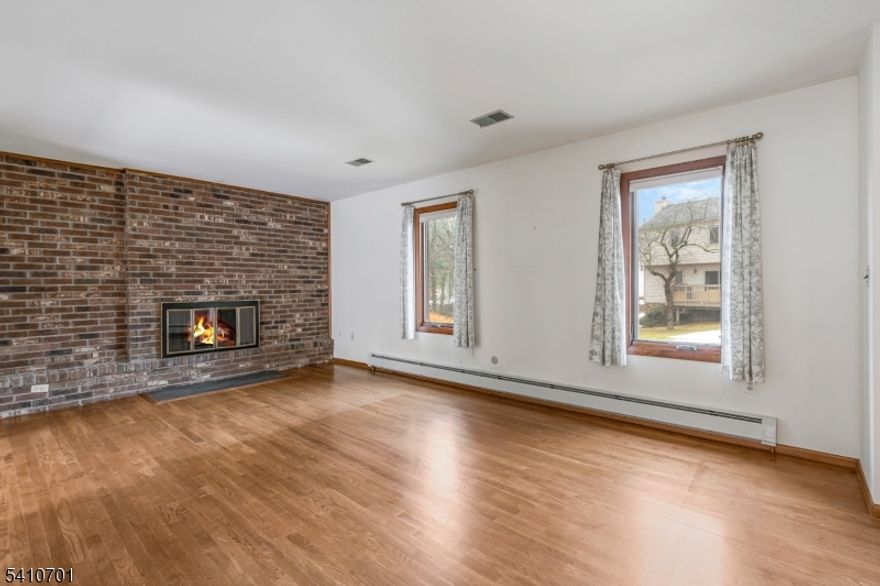 Welcome to Somerset Hills - Quiet Living with Unmatched Convenience.  Located just minutes from downtown Bernardsville shopping, dining, and major commuter routes, this well-maintained townhome offers the perfect blend of tranquility and accessibility.  The first floor features a bright kitchen, spacious living room with gas fireplace, and dining room with direct access to your own private deck ideal for relaxing or entertaining. A convenient half bath completes this level.  Upstairs, you'll find two generously sized bedrooms, including a primary bedroom with its own private half bath, plus an additional full bathroom.  The full unfinished basement provides excellent storage space or the potential to be finished for additional living area. An attached one-car garage adds extra convenience. Perfect as a starter home or a fantastic investment opportunity for those seeking a rental property in the Somerset Hills area.