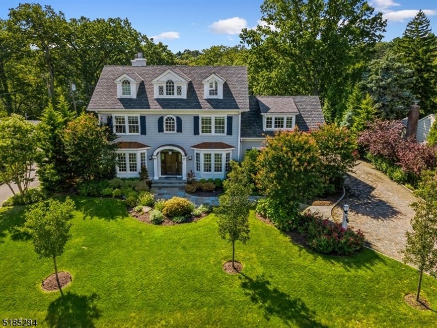 Exquisite, Sun-Filled Colonial sits atop of 11-acre picturesque Yantacaw Brook Park offering one of a kind panoramic views. Each room is breathtakingly beautiful and elegant offering soaring ceiling, stunning millwork and an abundance of natural light. Formal rooms on the first floor include living room with wood burning fireplace and custom shelving, dining room and formal powder room. The family room with another wood burning fireplace, sunroom and kitchen all have radiant heat and stunning panoramic views of the park. The chef inspired kitchen is loaded with special features including top of the line cabinetry & appliances, 4 sinks, coffee bar, and butler's pantry equipped with a 250-bottle wine cooler, another fridge and 3rd dishwasher. 2nd powder completes the 1st level. Upstairs is a stunning Primary Suite boasting vaulted ceiling, gas fireplace, dual custom closets, lux marble bath with double vanity, steam shower, deep soaking tub & heated floors plus access to second floor deck with retractable awning overlooking the gorgeous park. 3 add'l bedrms, 2 with ensuites, full bath, plus den & laundry complete 2nd level. Expansive 3rd flr bedrm suite has full bath & space for media/ work. LL has media/game rm, spectacular gym with custom flooring, full bath, bedrm & plenty of storage. Lush backyard has multiple entertaining spaces with great views of the park. Two-car garage is finished and offers epoxy flooring & custom storage. Total living space as per owner.