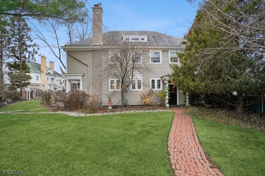 Own a rare piece of Plainfield history at 944 Madison Avenue. This distinctive 3,900 sq ft residence was built in 1897 as the carriage house to the iconic Coriell Mansion, the largest home ever constructed in the Queen City. Located in the Van Wyck Brooks Historic District, the property offers architectural integrity and timeless character rarely found today. The home has been featured in architectural publications and on historic home tours. Original craftsmanship is showcased throughout, including high ceilings, exposed beams, French doors, original wainscoting, stained-glass accents, and leaded transom windows. 5 gas fireplaces add warmth and old-world charm. The kitchen features a Viking range, stainless steel appliances, and a layout designed for entertaining. A generously sized dining room flows seamlessly into the main living areas. Set far off the street, mature hedges provide exceptional privacy. Expansive front and side yards, a detached two-car garage, and inviting outdoor spaces complete the setting. A summer kitchen opens to a patio and screened porch for easy indoor-outdoor living. The ground level offers flexible rooms with a full bath, ideal for a studio, home office, or recreation space. The main living level includes a primary suite, guest bedroom, additional full bath, and open living and dining areas. The third floor provides an additional bedroom or office and a full walk-in attic. A truly exceptional opportunity to own a one-of-a-kind historic residence.