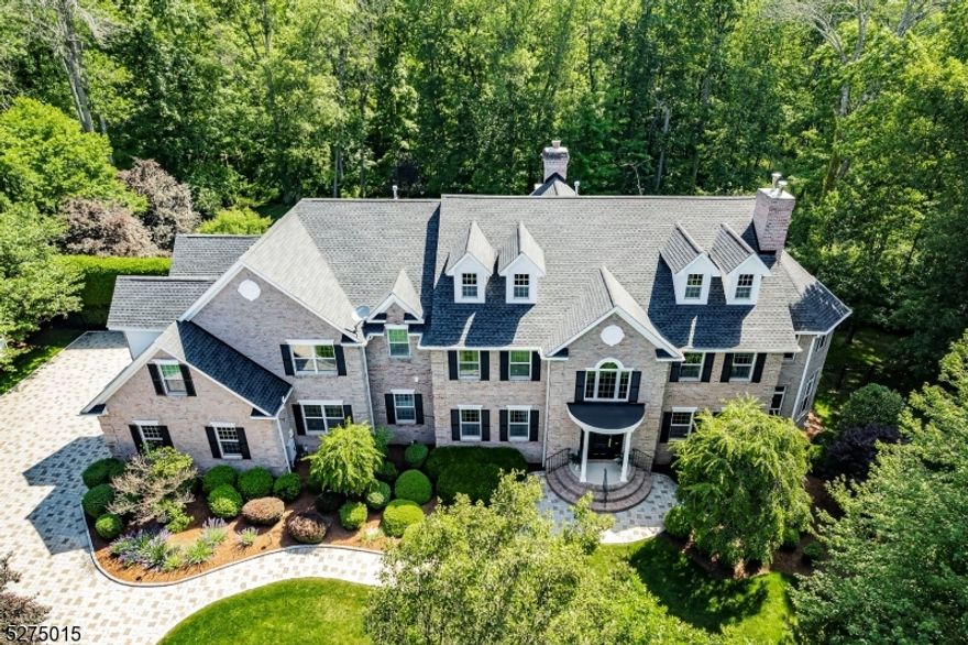 Tucked away in a serene cul-de-sac, this exquisite custom brick colonial is a must see that sits on nearly 6 acres of lush greenery, adorned with mature trees and vibrant plantings.  This beautiful home includes six bedrooms - five bedrooms plus a media room and recreation room on the second level - and an additional bedroom and full bath on the first level.  Boasting an array of luxurious features, including soaring ceilings, a 4-car garage, 4 cozy fireplaces, a refreshing pool with a charming cabana, a pavilion with fireplace and outdoor kitchen, and a sophisticated wine cellar, the spacious layout is even further enhanced by intricate moldings.  The home also features a handsome wood-paneled library, a bright sunroom, a generous eat-in chef's kitchen equipped with top-of-the-line appliances, an elevator that conveniently serves all three levels, and a full house generator for added convenience.  A fully-finished basement offering a sizable exercise room, a dance studio, and another full bath completes this amazing space.