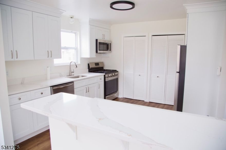 WOW FACTOR!!!!  STUNNING, TOTALLY UPDATED 2 bedroom, 2 bathroom  END UNIT at Hanover Park. This home features a gorgeous gourmet style kitchen with sleek quartz countertops and stainless-steel appliances with breakfast bar and pantry. Primary suite includes a full bathroom and two closets. Updated bathrooms provide a luxurious, modern touch, new flooring throughout, freshly painted, new a c, new furnace. Enjoy relaxing in the spacious living room, and entertaining in the formal dining room, overlooking the scenic views from the lovely balcony. Upscale living at a very affordable price! Conveniently located near major highways, shopping, restaurants, NYC trans. Enjoy this fabulous lifestyle living in this wonderful community...two assigned parking spaces, community pool, playground and plenty of visitor parking. Nothing to do but move right in and enjoy!