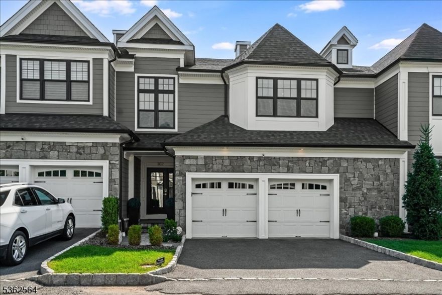 Welcome to 302 Tiffany Way a beautifully crafted Villa Capri model offering refined finishes, smart functionality, and low-maintenance living in one of Watchung's most desirable communities. With nearly 3,000 square feet of upscale living and an additional 1,000+ sq ft walkout lower level, this 3-bedroom, 3.1-bath townhome lives large in all the right ways.Inside, you're greeted by an open, airy layout bathed in natural light. The fireside living room flows seamlessly into a custom chef's kitchen featuring a dramatic waterfall quartz island, Bertazzoni appliances, full-height quartz backsplash, and custom cabinetry that marries elegance with utility.Upstairs, the expansive primary suite is a true retreat offering dual walk-in custom closets, an electric fireplace, and a spa-inspired bath with soaking tub,oversized glass shower, and designer finishes. Two additional bedrooms provide flexibility for guests, work-from-home, or creative space.The fully finished walk-out lower level offers even more complete with a full bath, fitness area, media/lounge space, and built-ins that elevate the everyday. Step outside to a private patio or enjoy peaceful mornings and sunset cocktails on the deck off the main living area lushly landscaped for year-round enjoyment.All this, just minutes to top-rated schools, major highways, shops, restaurants, and Watchung's beautiful parks and lakefront paths.302 Tiffany Way delivers the best of both worlds luxury living with a lock-and-leave lifestyle.