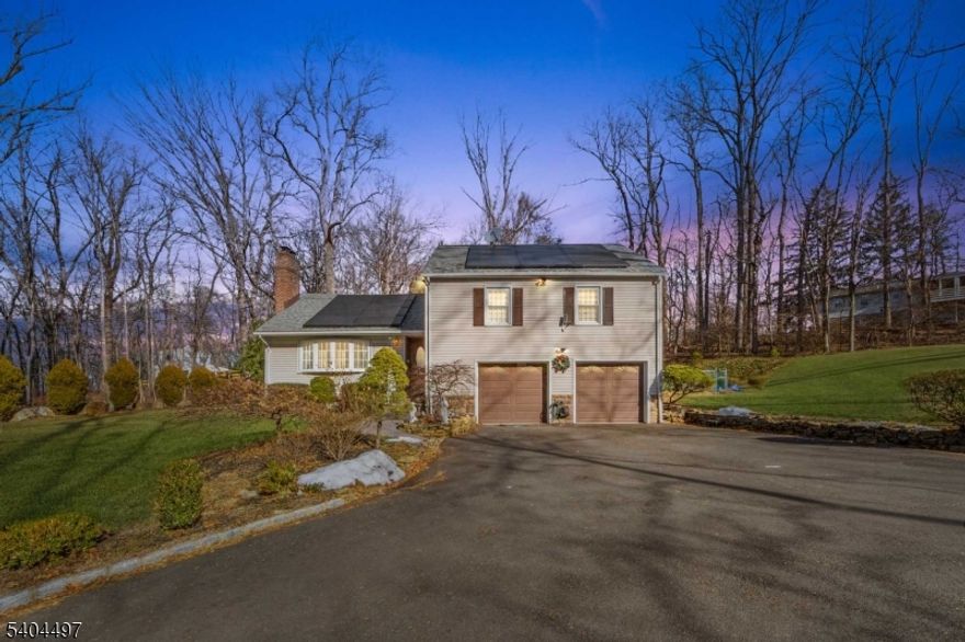 Set on an approximately 38,002 square foot lot (approximately 0.87 acres), this 1950s split-level home offers 9 rooms, 4 bedrooms, and 3 1/2 baths with a flexible multi-level layout ideal for everyday living and entertaining. The main level features a foyer, living room with fireplace, dining room, and an eat-in kitchen with direct access to the deck for easy indoor-outdoor flow, while the upper level includes a primary bedroom with en-suite bath, three additional bedrooms, and a full hall bath. The ground level provides convenient daily-use spaces including an attached two-car garage, recreation room, laundry area, and additional bath accommodations, and a fully finished basement adds versatile space for media, fitness, hobbies, or storage. Outdoors, the expansive backyard is anchored by a heated in-ground pool, creating a private retreat for summer enjoyment. Additional highlights include central air conditioning, hot water baseboard heat (oil), hardwood flooring (as-is), a sprinkler system, solar system, well water, septic, and flexible possession.